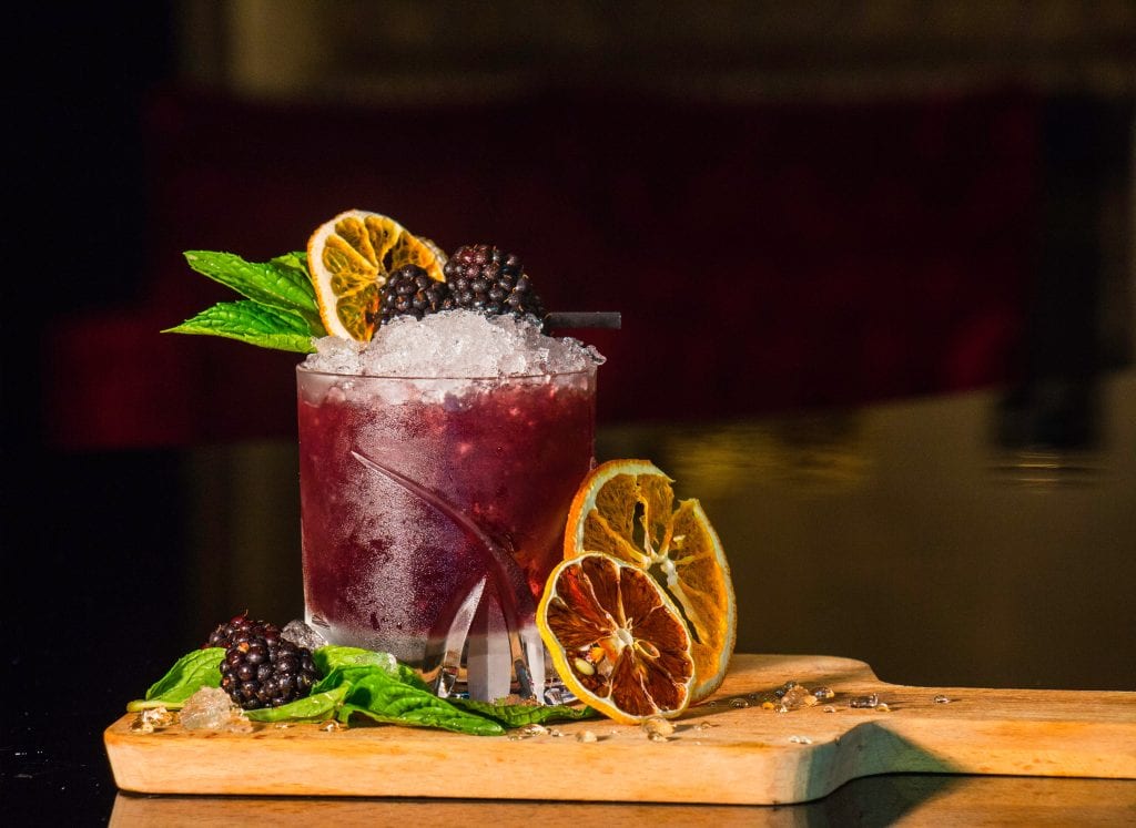 blackberry cocktail garnished with fresh fruit