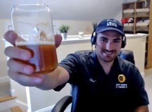 a beer guide holds a beer up to the camera