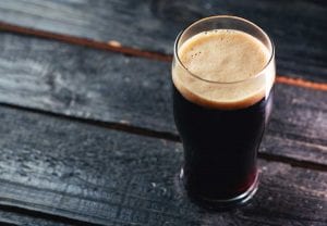 a dark beer sits on a table