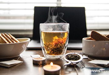 mug of tea steaming with a candle