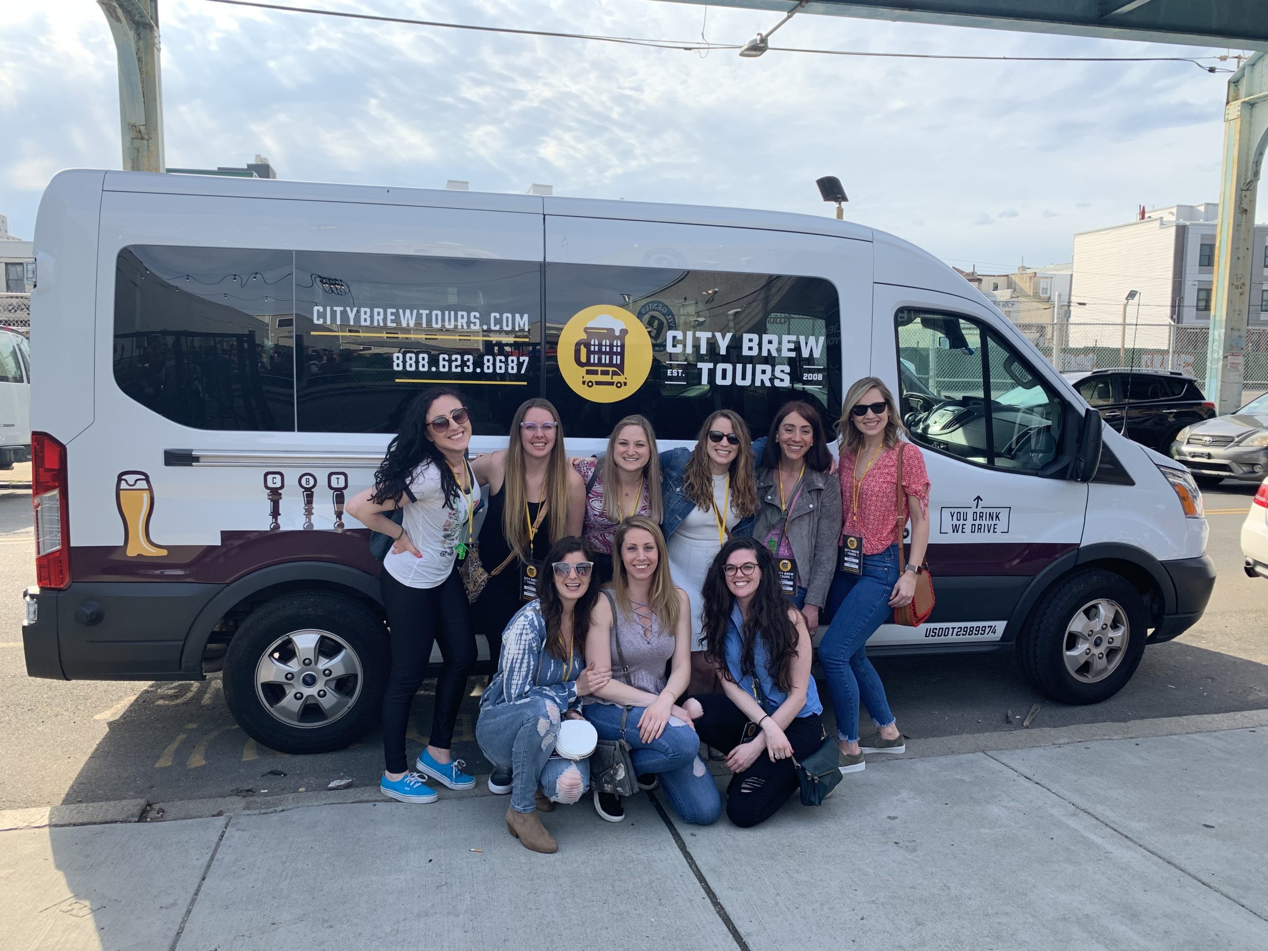 A bachelorette party poses in front of the Brew Tour van during their private tour