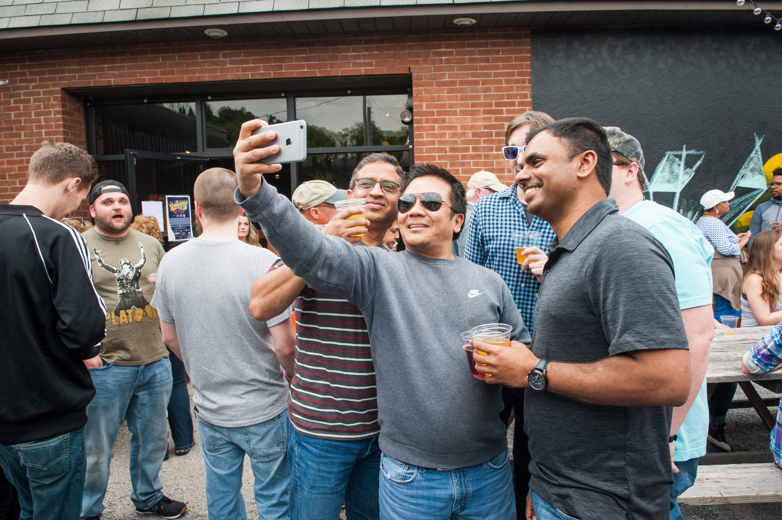 Bachelor party snaps a selfie with beers in hand