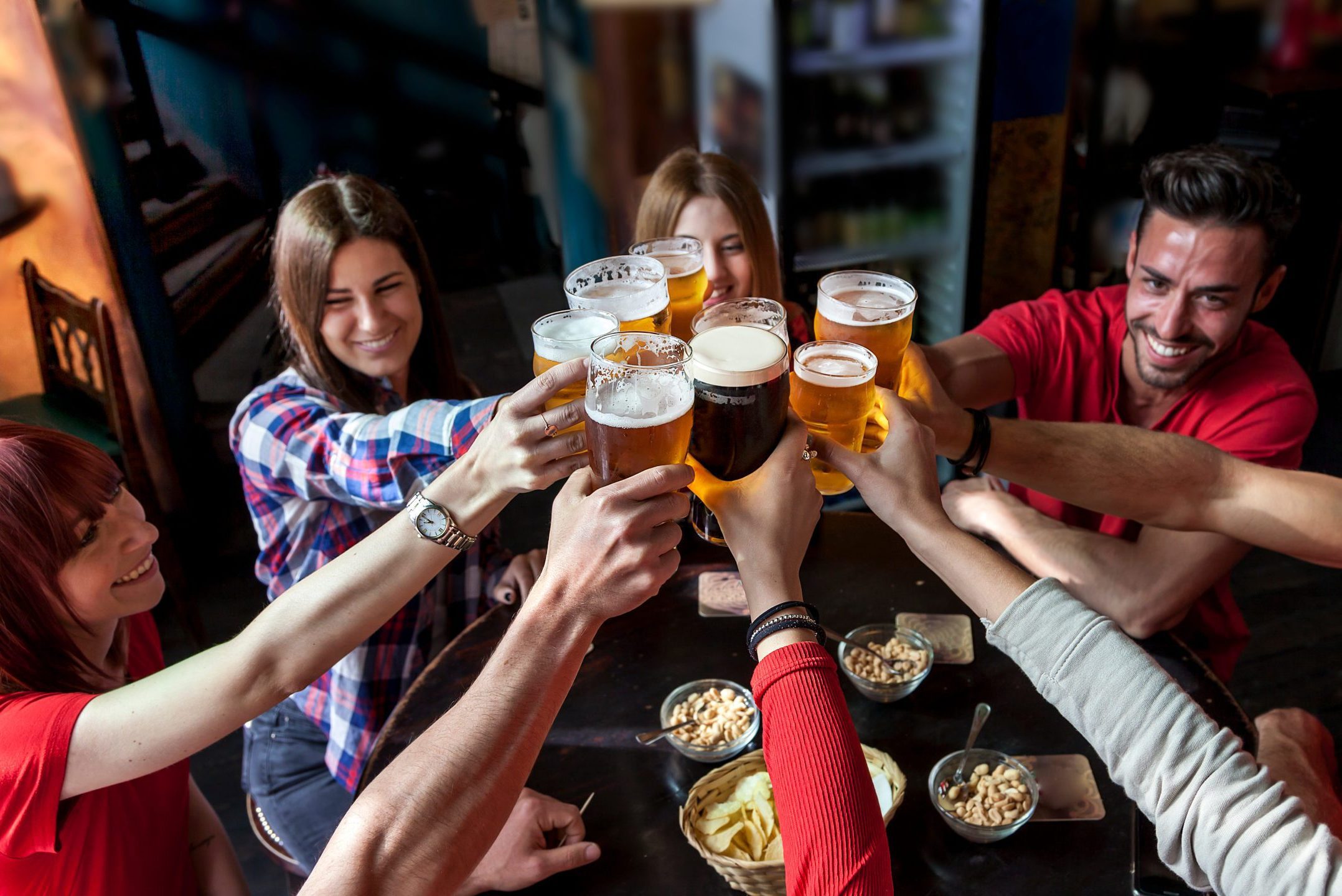 A group toasts with beers