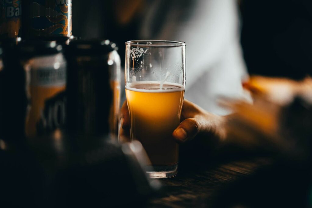 Someone enjoying a fresh craft beer in a pub