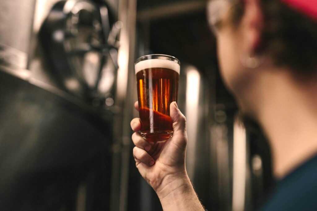 Beer craftsman observing the quality of the beer he produced