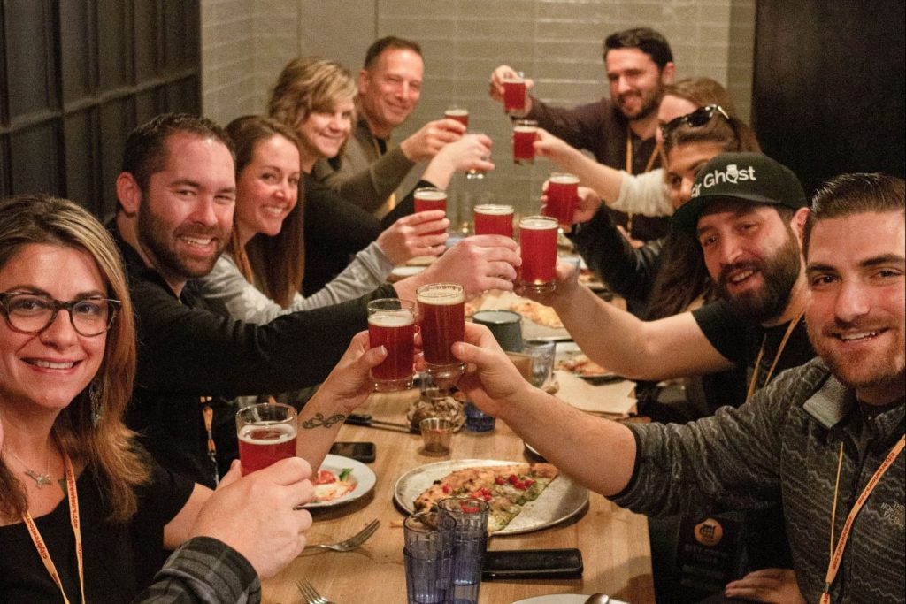A City Brew Tours group raises beer glasses in a toast