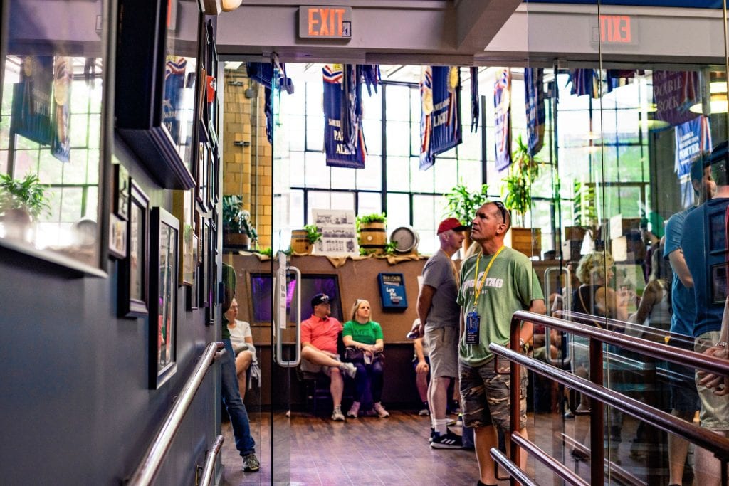 A City Brew Tours' guest stands inside Samuel Adams' Boston Brewery