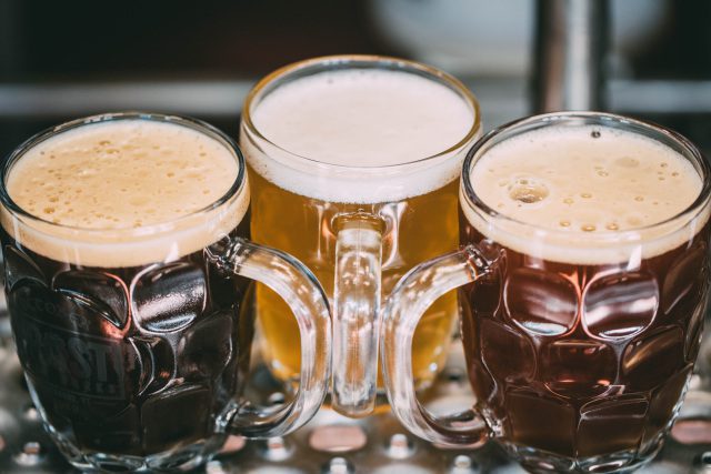 Three glass mugs of Frost Beer Works' beer