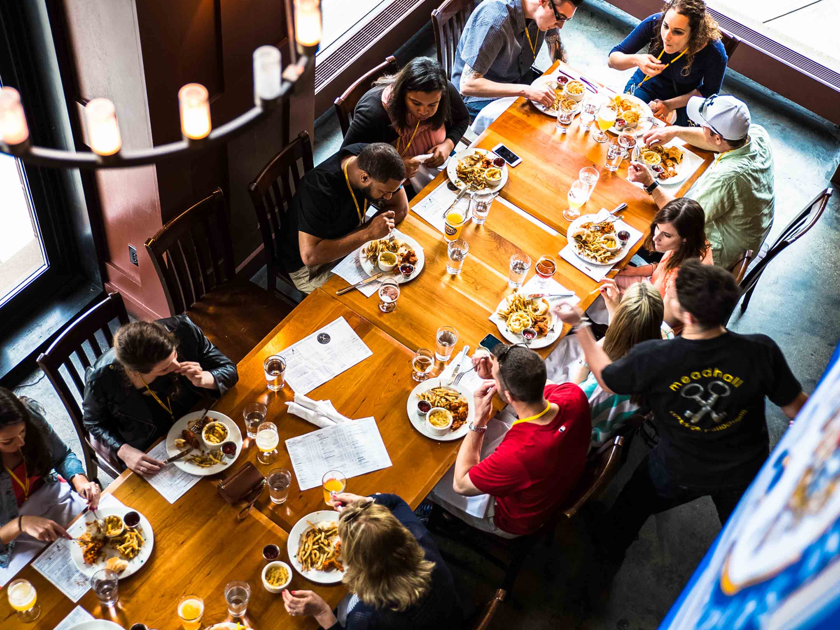 A large group of City Brew Tours Pittsburgh guests dine at Meadhall on their tour.